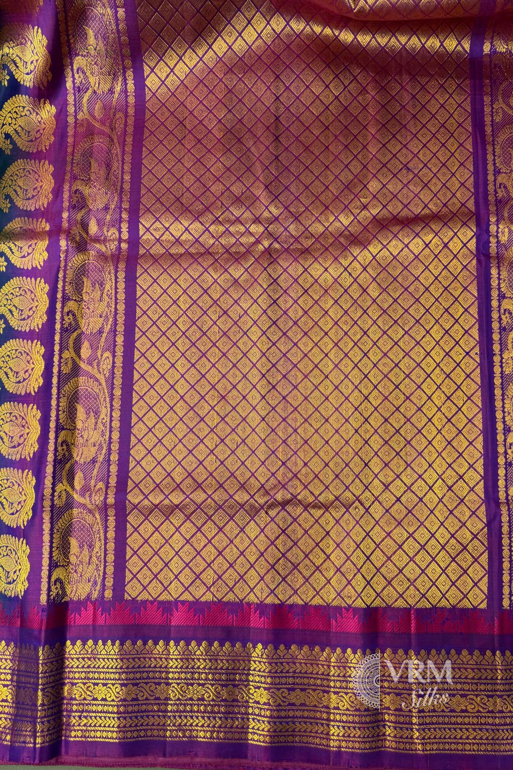 Close-up of purple border with gold zari weaving Close-up of purple border with gold zari weaving